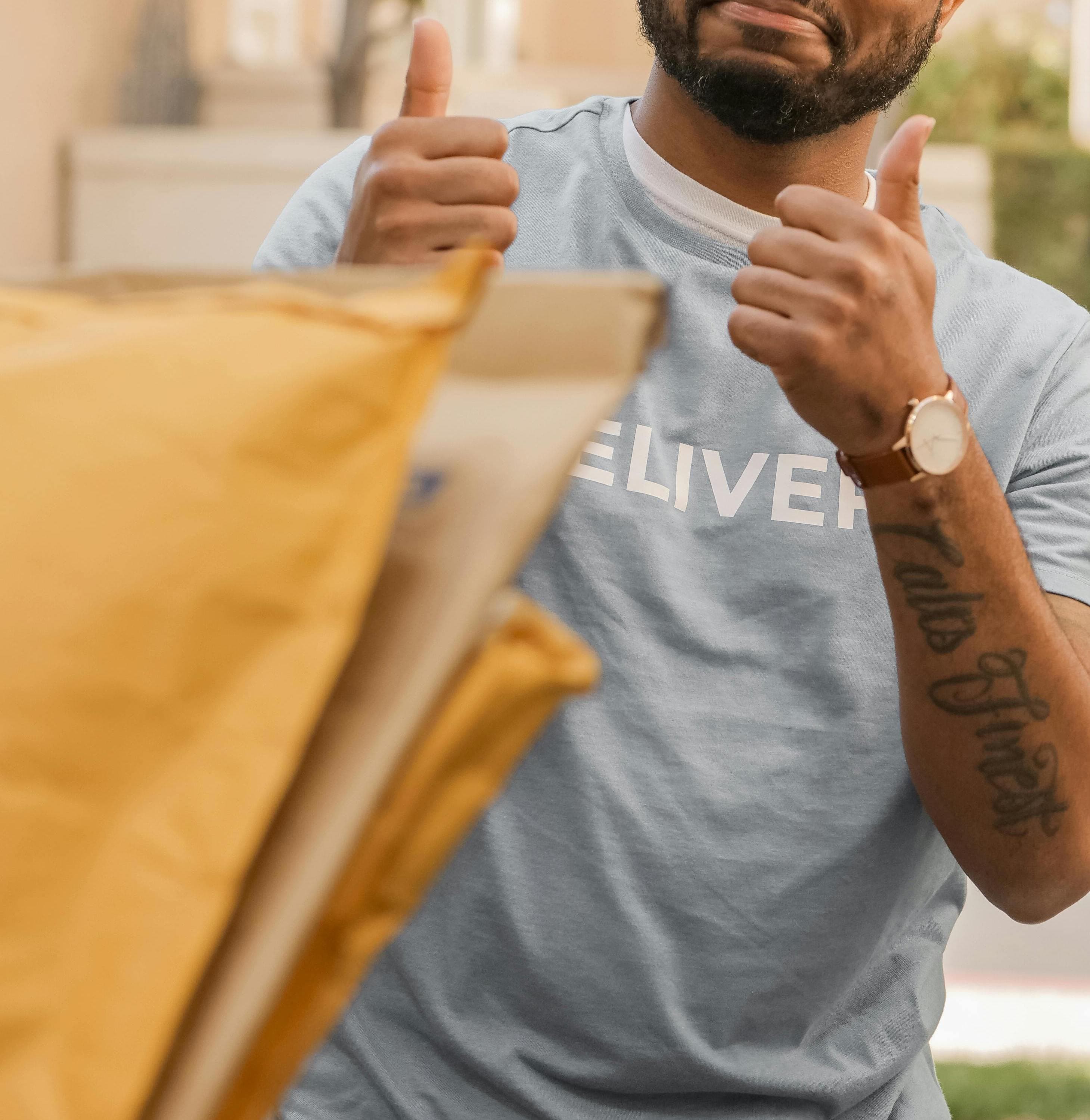 Courier showing approval while handing over delivered packages